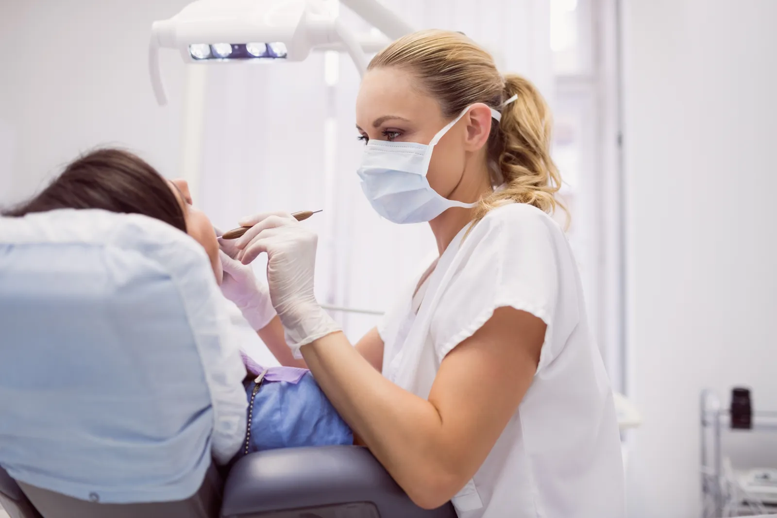 Dentist examining a patient during a routine check-up