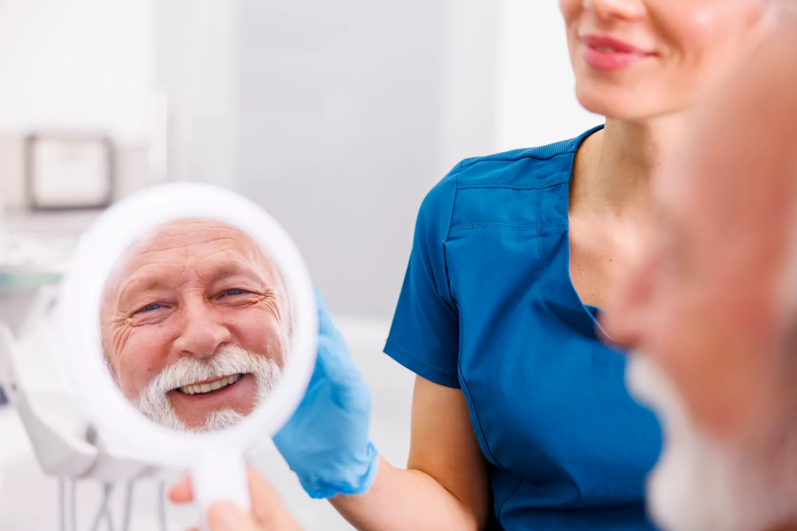 Older man smiling after having dental implants placed